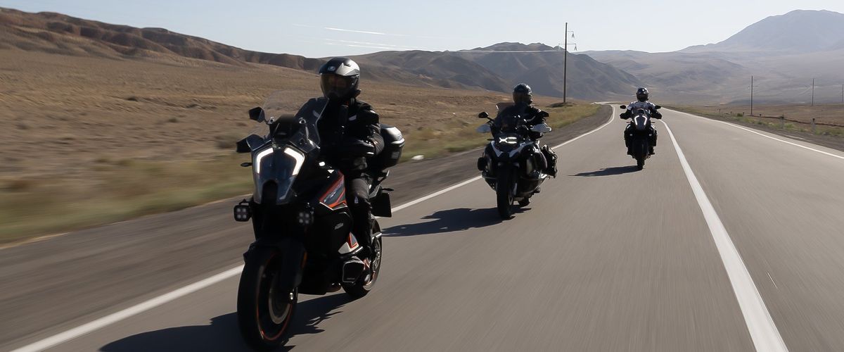 Riders on an open road at golden hour
